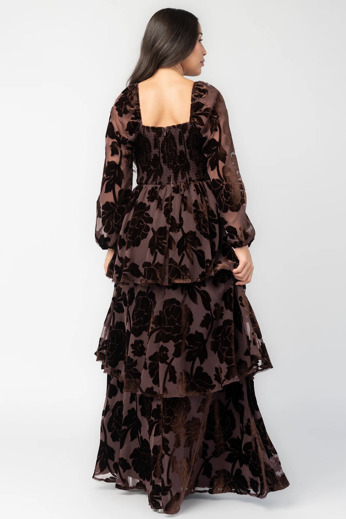 Alexandra Velvet Maxi Dress in Dark Brown with velvet florals, sweetheart neckline, long sleeves, smocked back, and flowing skirt.