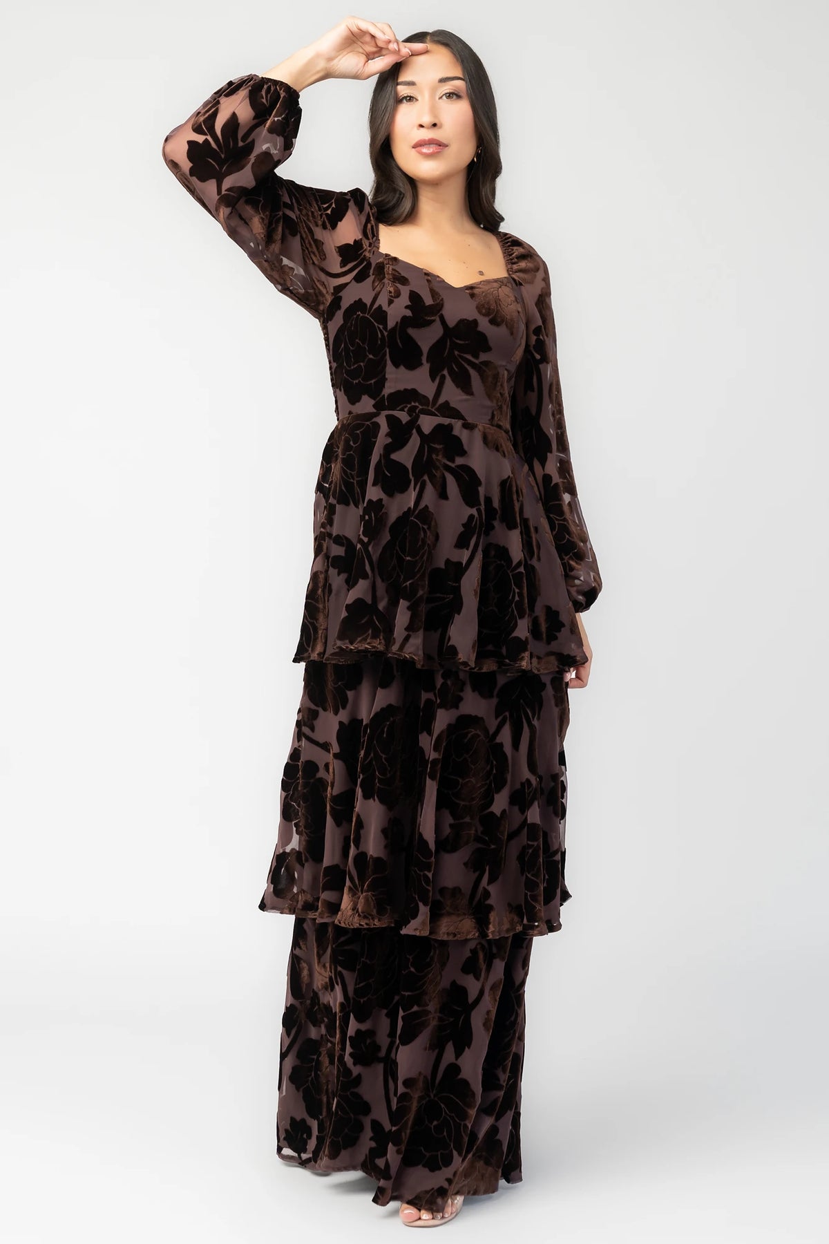 Alexandra Velvet Maxi Dress in Dark Brown with velvet florals, sweetheart neckline, long sleeves, smocked back, and flowing skirt.