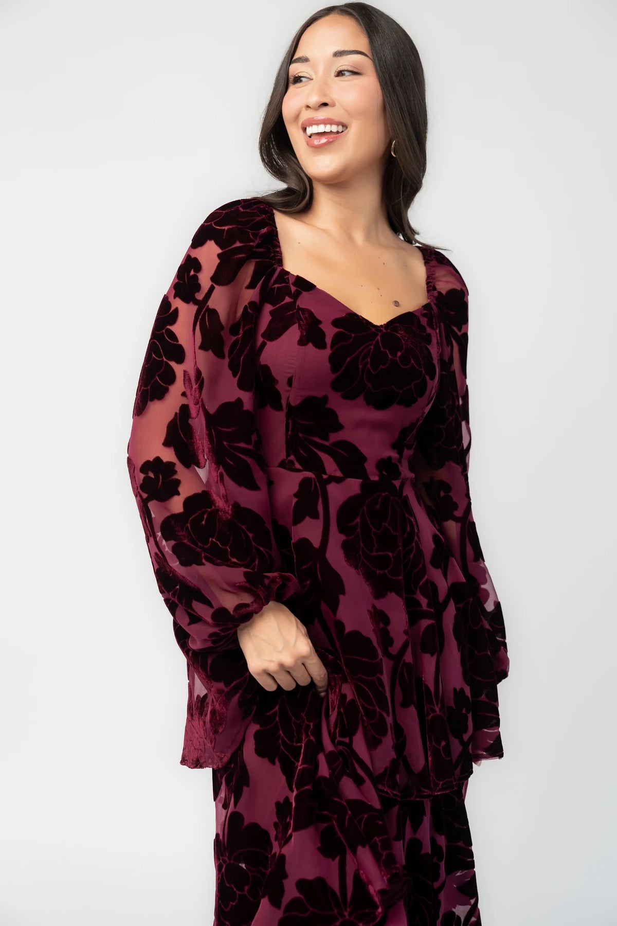 Alexandra Velvet Maxi Dress in Mulberry with velvet florals, sweetheart neckline, long sleeves, smocked back, and flowing skirt.