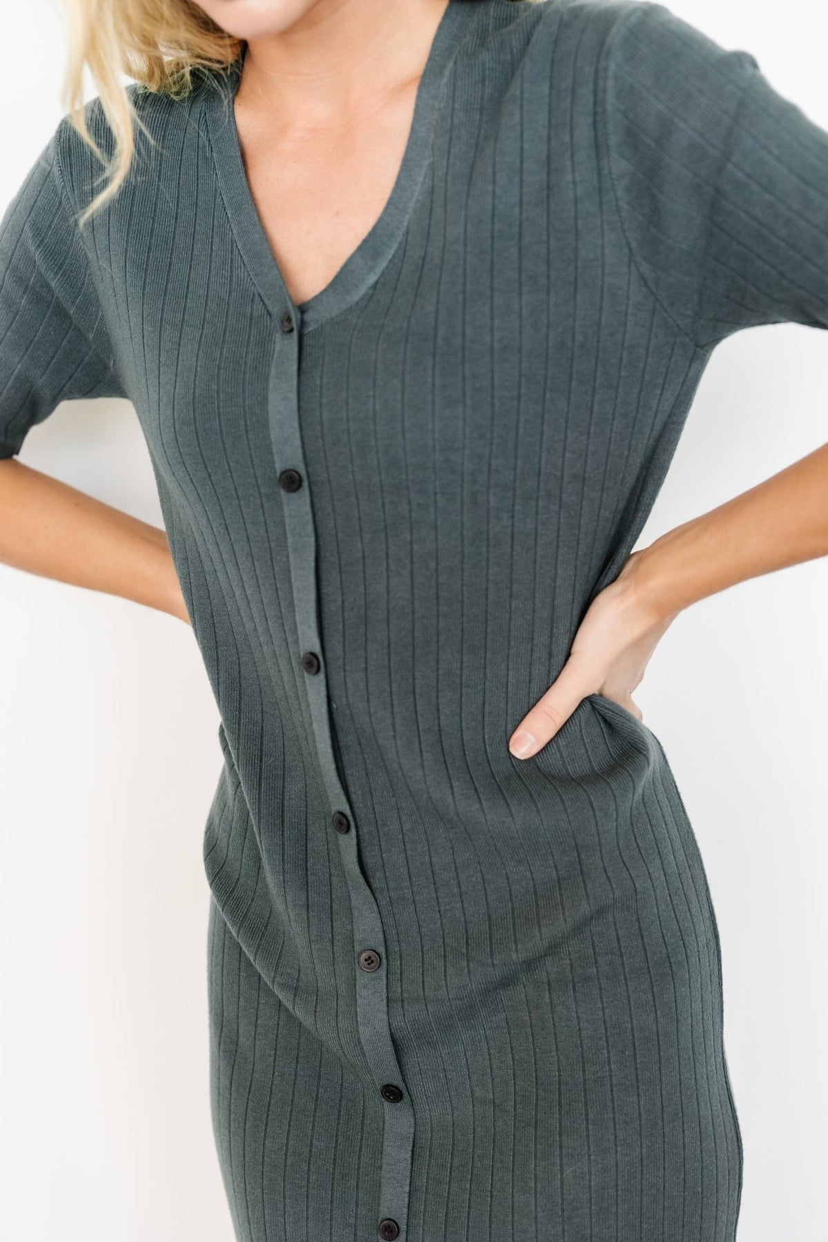 Three-quarter view of Alicia dusty jade midi dress on model, highlighting the relaxed silhouette, V-neckline, and comfortable pullover styling.