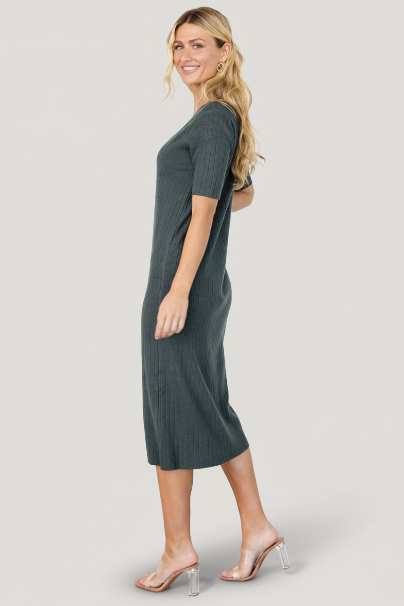 Side profile of Alicia ribbed midi dress in dusty jade, showing the mid-calf length, short sleeves, and how the fabric skims the body.