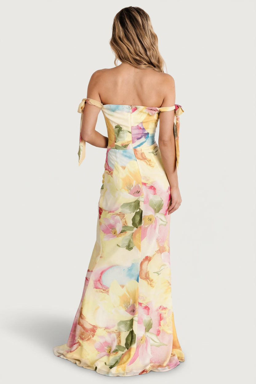 Full-length on-model image showing chiffon tulip skirt movement and adjustable off-shoulder bow straps for an elegant wedding-guest look.