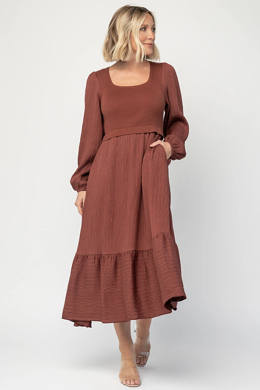 Alva Sweater Dress in Dusty Mahogany with ribbed knit bodice, square neckline, ruffle shoulders, long sleeves, and midi skirt.