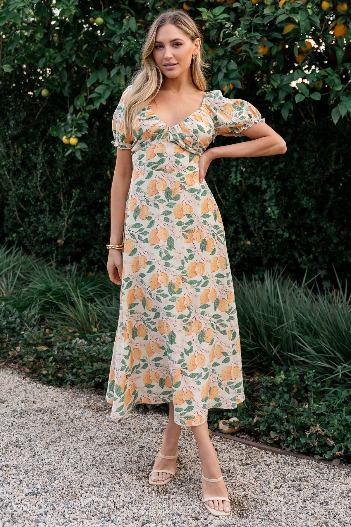 Close-up of Amalfi midi fabric showing textured rayon blend, lemon print, ascending point paneling beneath the bust, and stitched detailing.