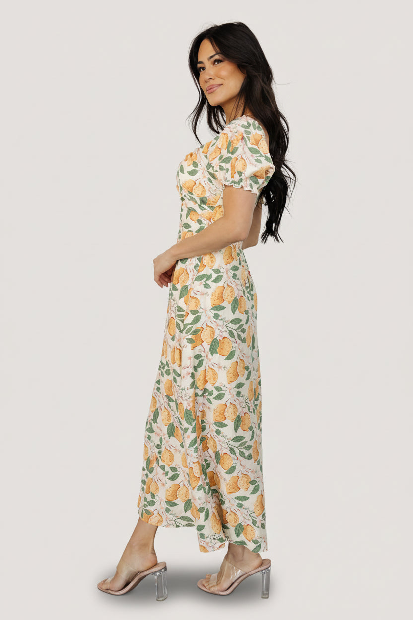 Detail shot of sleeve cuff and smocking on the Amalfi lemon-print midi, showing elastic cuff, soft gathers, and fabric texture.