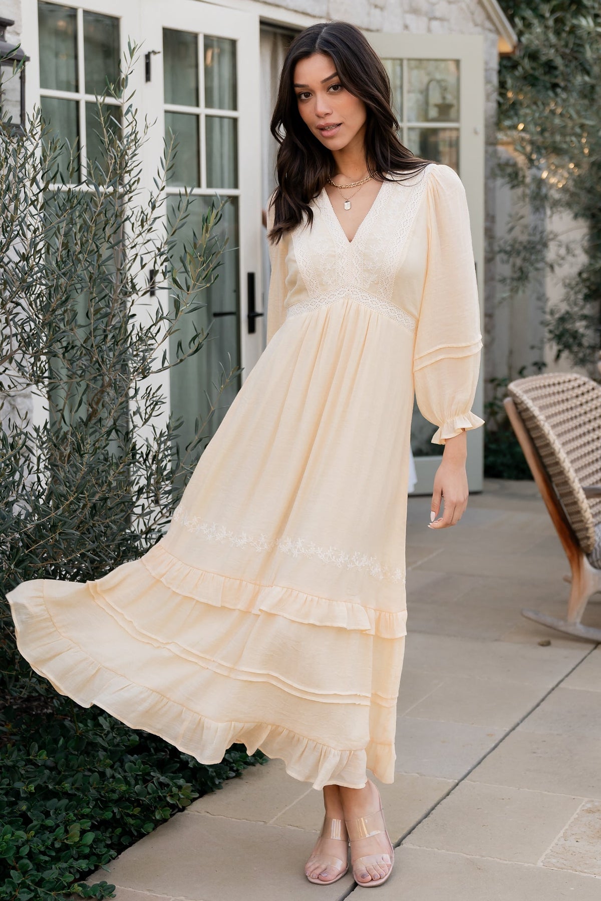 Full-length shot of Amberlee embroidered midi dress in cream showing tiered skirt movement and delicate embroidery.