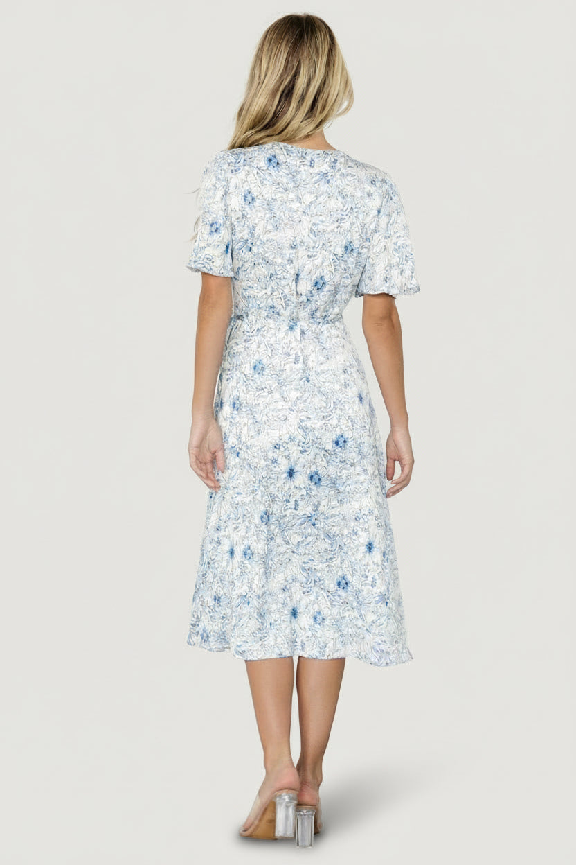 Detail image of the self-tie waist and wrap closure on the Amelie Wrap Midi Dress in blue floral print.