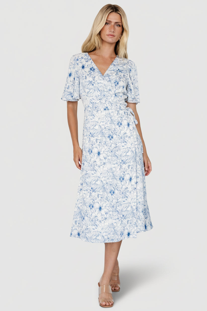 Front view of Amelie Wrap Midi Dress in blue-and-off-white floral crepe, showing flutter sleeves and midi-length hem.