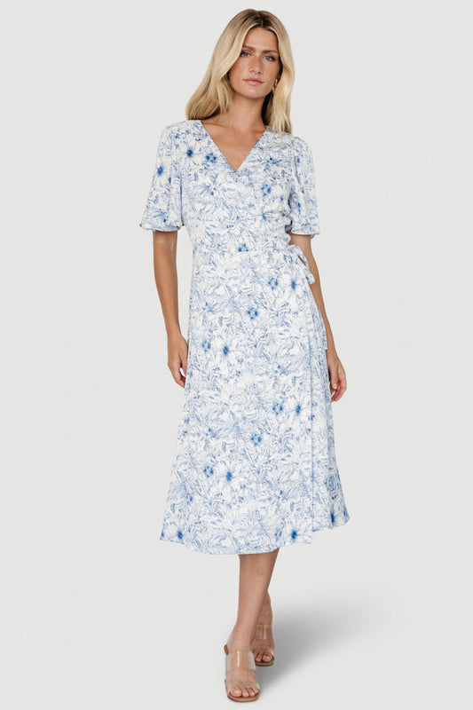 Front view of Amelie Wrap Midi Dress in blue-and-off-white floral crepe, showing flutter sleeves and midi-length hem.