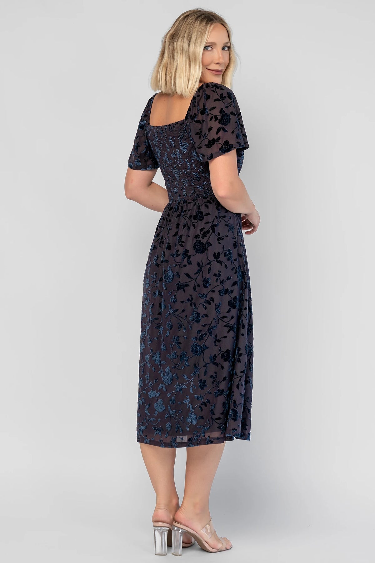 Amoret Midi Dress in Midnight Navy Floral with raised velvet florals, a sweetheart neckline, and flutter sleeves.