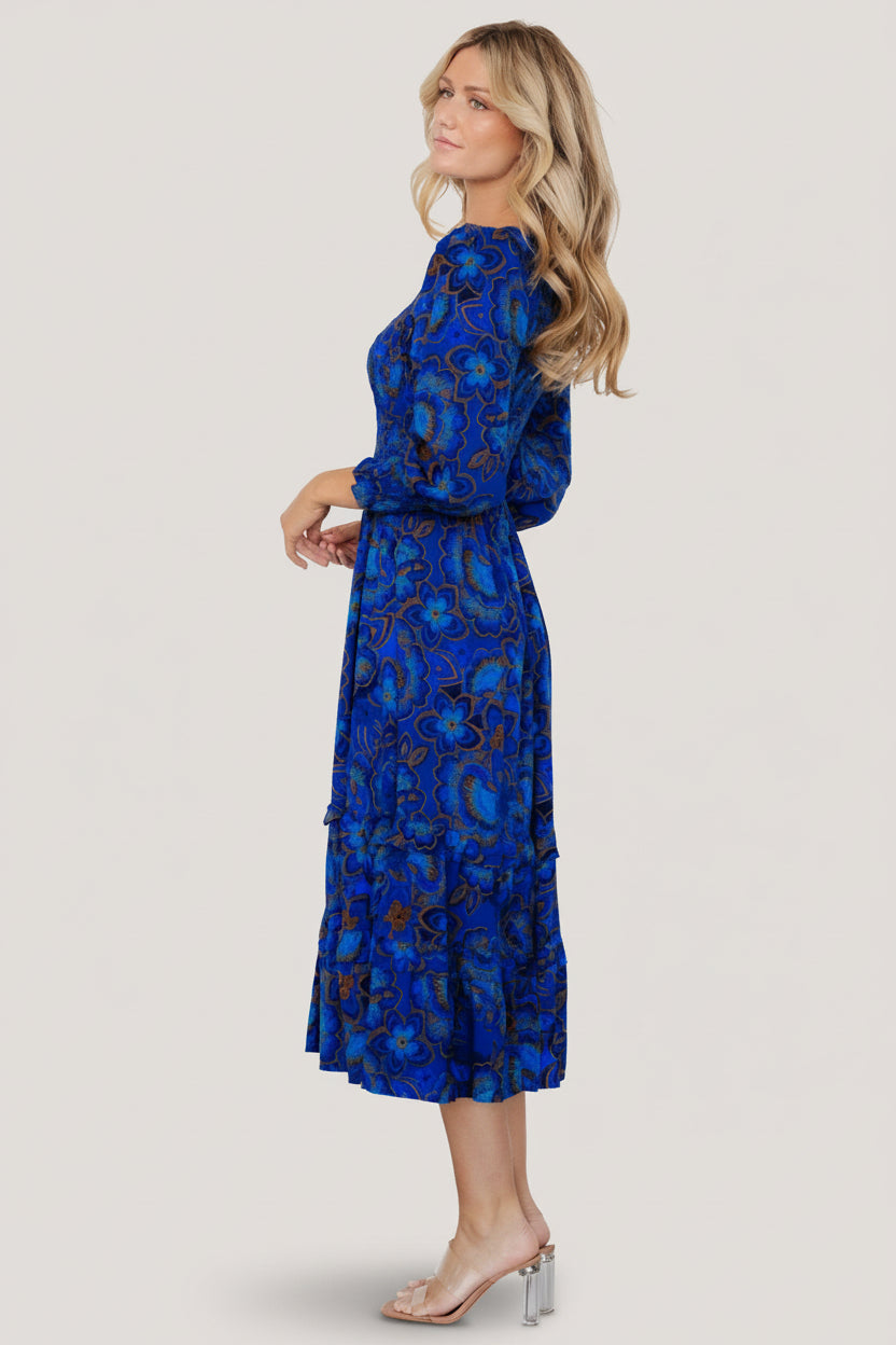 Close-up of smocked bodice and smocked cuffs, showing floral print and fabric texture.