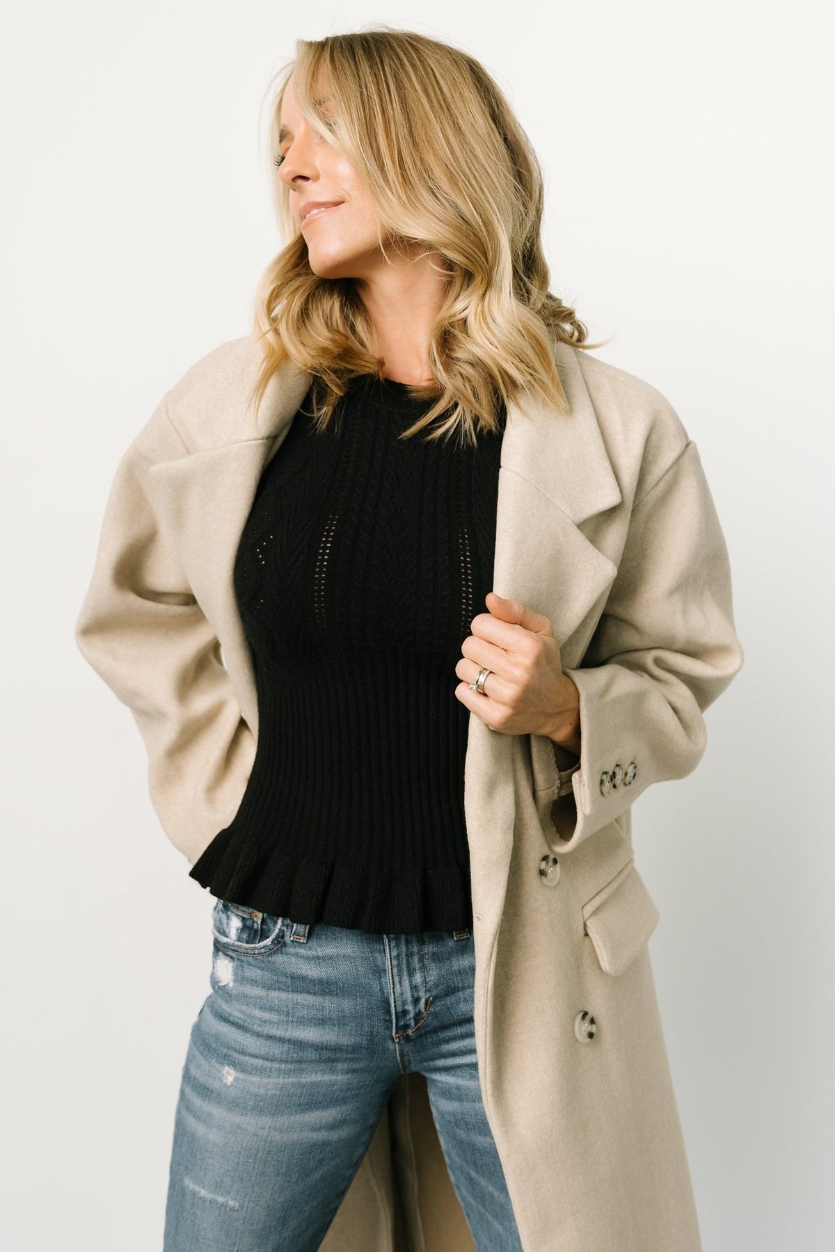 Styled outfit shot with Anderson coat in natural, showing versatile daytime-to-evening styling and the coat's neutral palette.