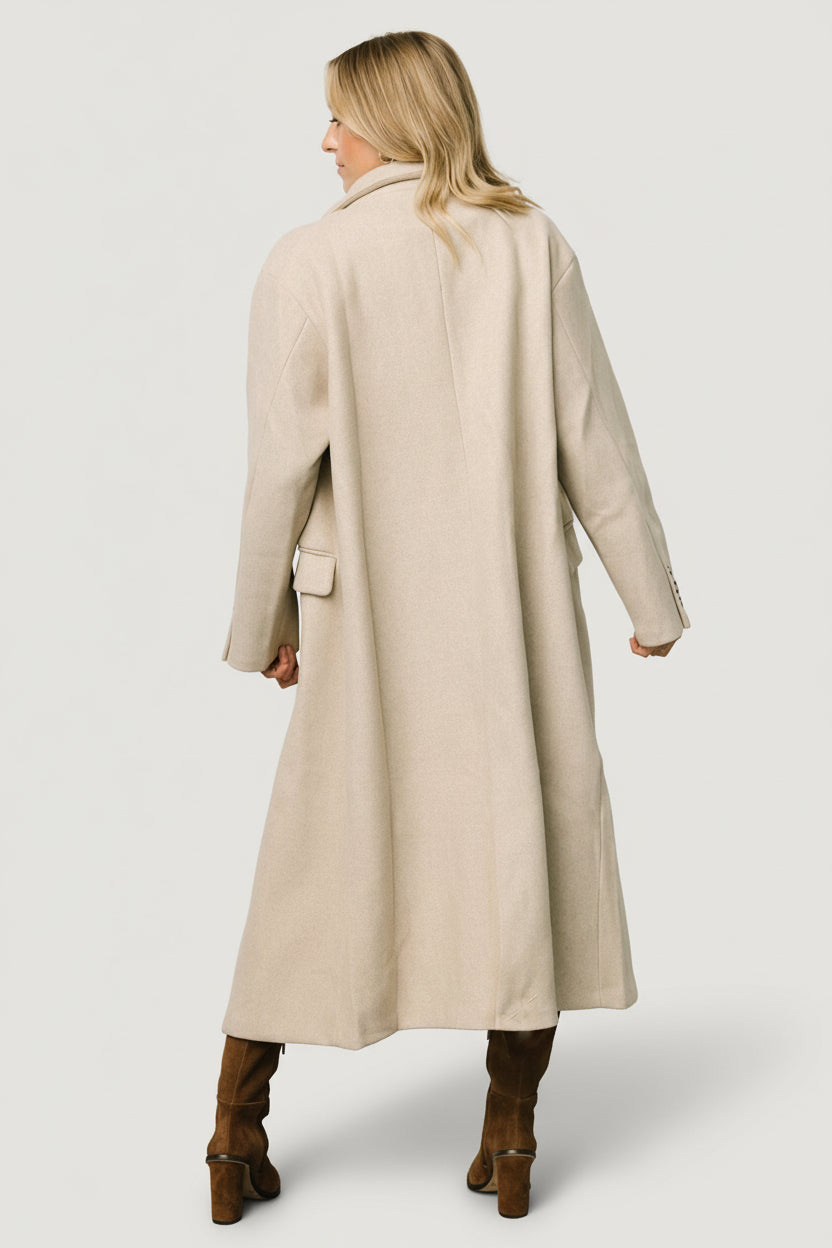 Back and hem detail of Anderson double-breasted coat in natural, illustrating length, cut, and brushed fabric drape.