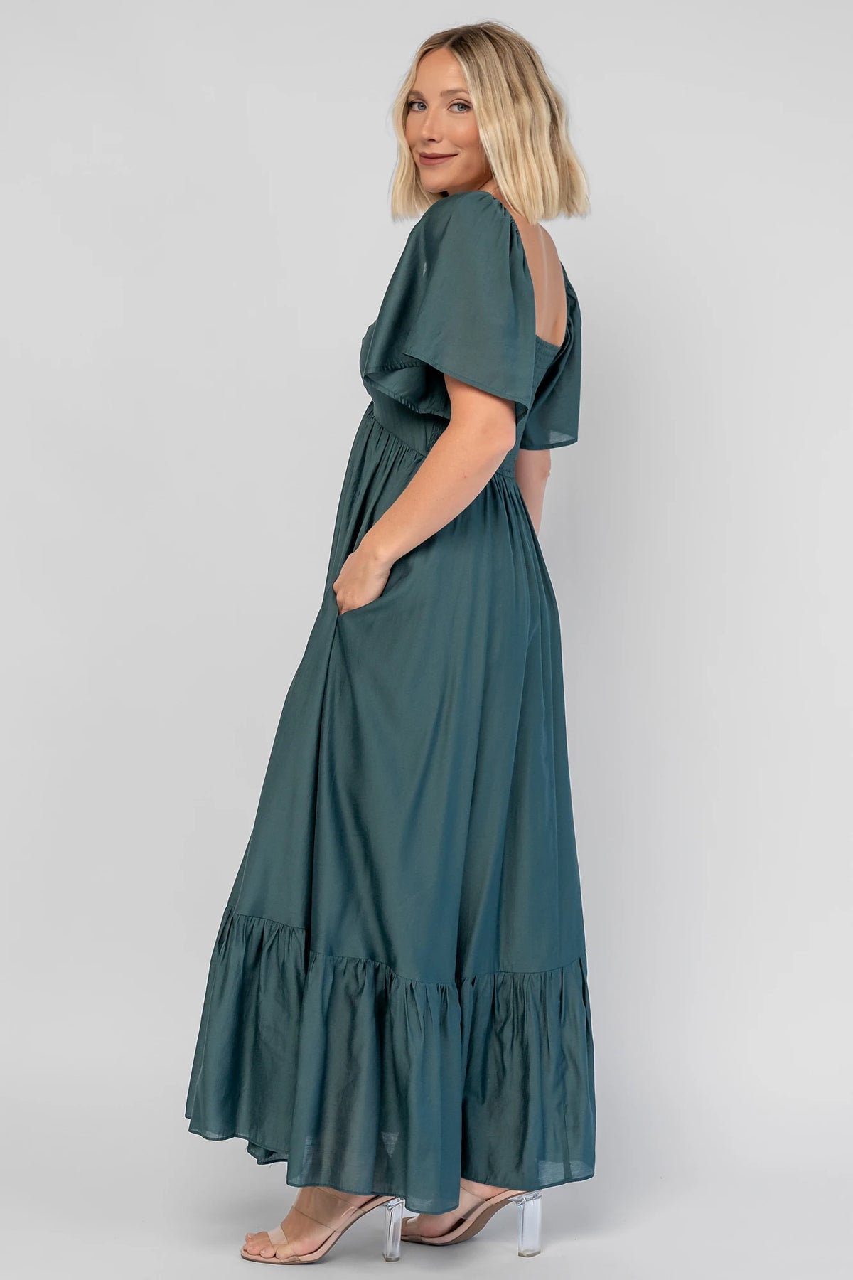 Anisa Midi Dress in Emerald with a V-neckline, cinched bust, and elastic shoulders.