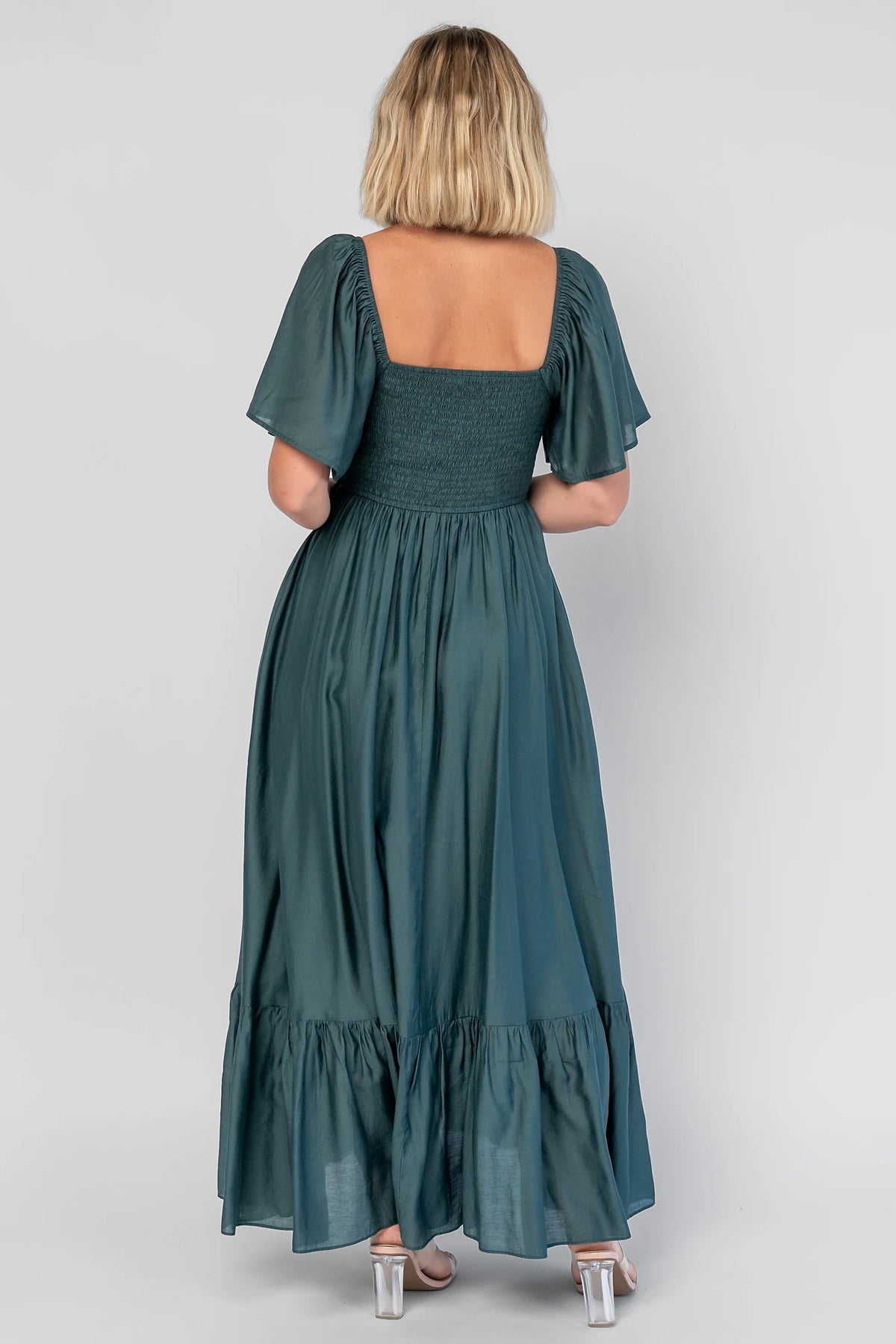 Anisa Midi Dress in Emerald with a V-neckline, cinched bust, and elastic shoulders.