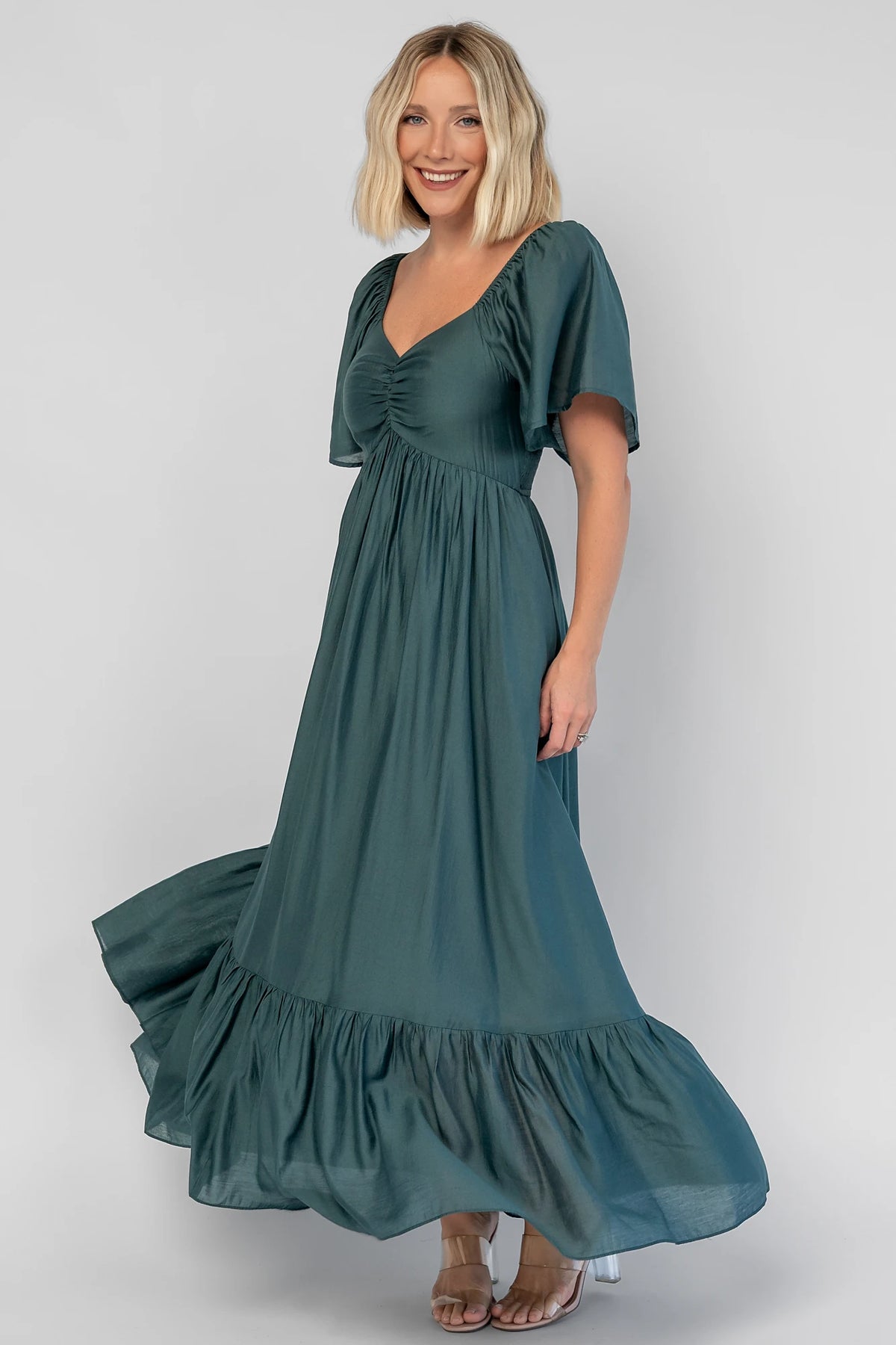 Anisa Midi Dress in Emerald with a V-neckline, cinched bust, and elastic shoulders.