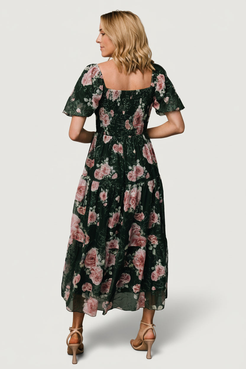 Three-quarter view of the dark green midi dress highlighting the gathered Florentine neckline, bloused bust, and smocked back bodice.