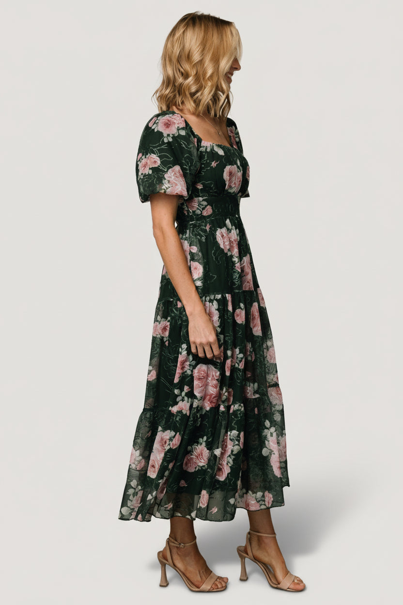 Side view of midi-length skirt with three tiers and soft movement, showing hidden side pocket placement and empire waist seam.