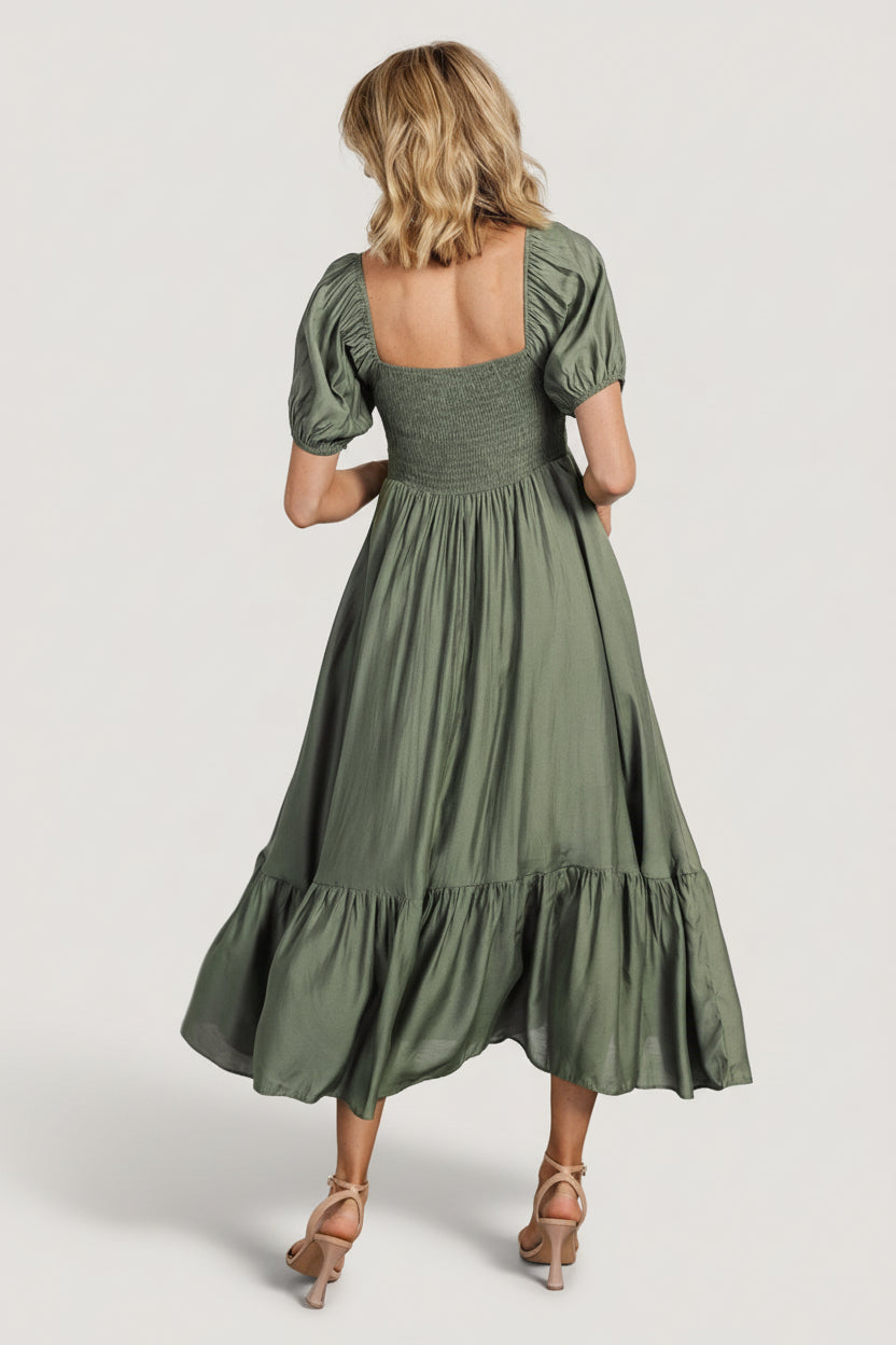 Detail shot of the Annalisa dress sleeve and gathered bust in dusty olive, illustrating puff sleeve shape and lining.