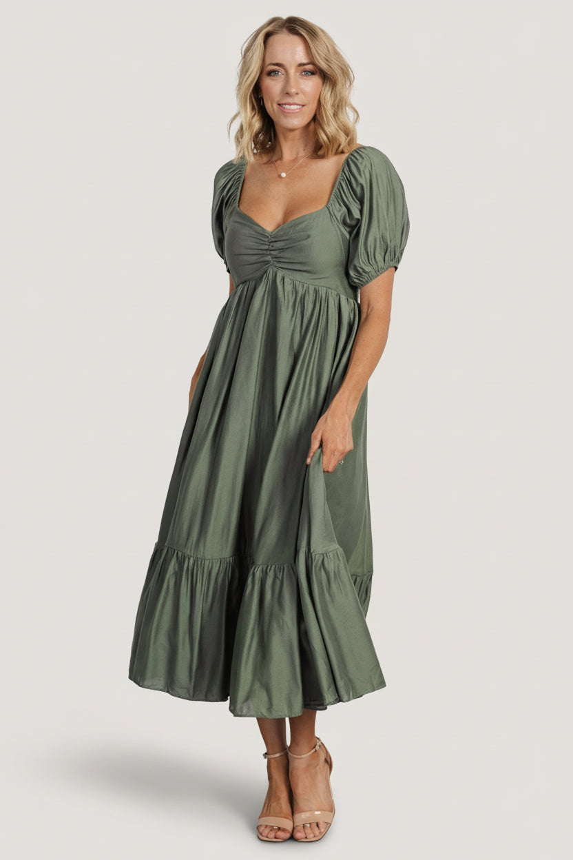 Front studio view of the Annalisa midi dress in dusty olive showing wide sweetheart neckline, smocked back, and tiered midi skirt.