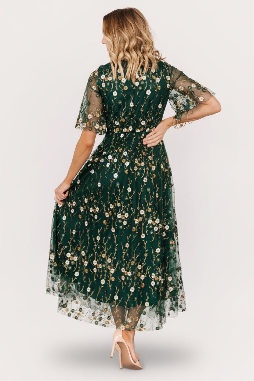Styled look of Arabella maxi dress paired with minimal accessories to showcase embroidered detail and movement.