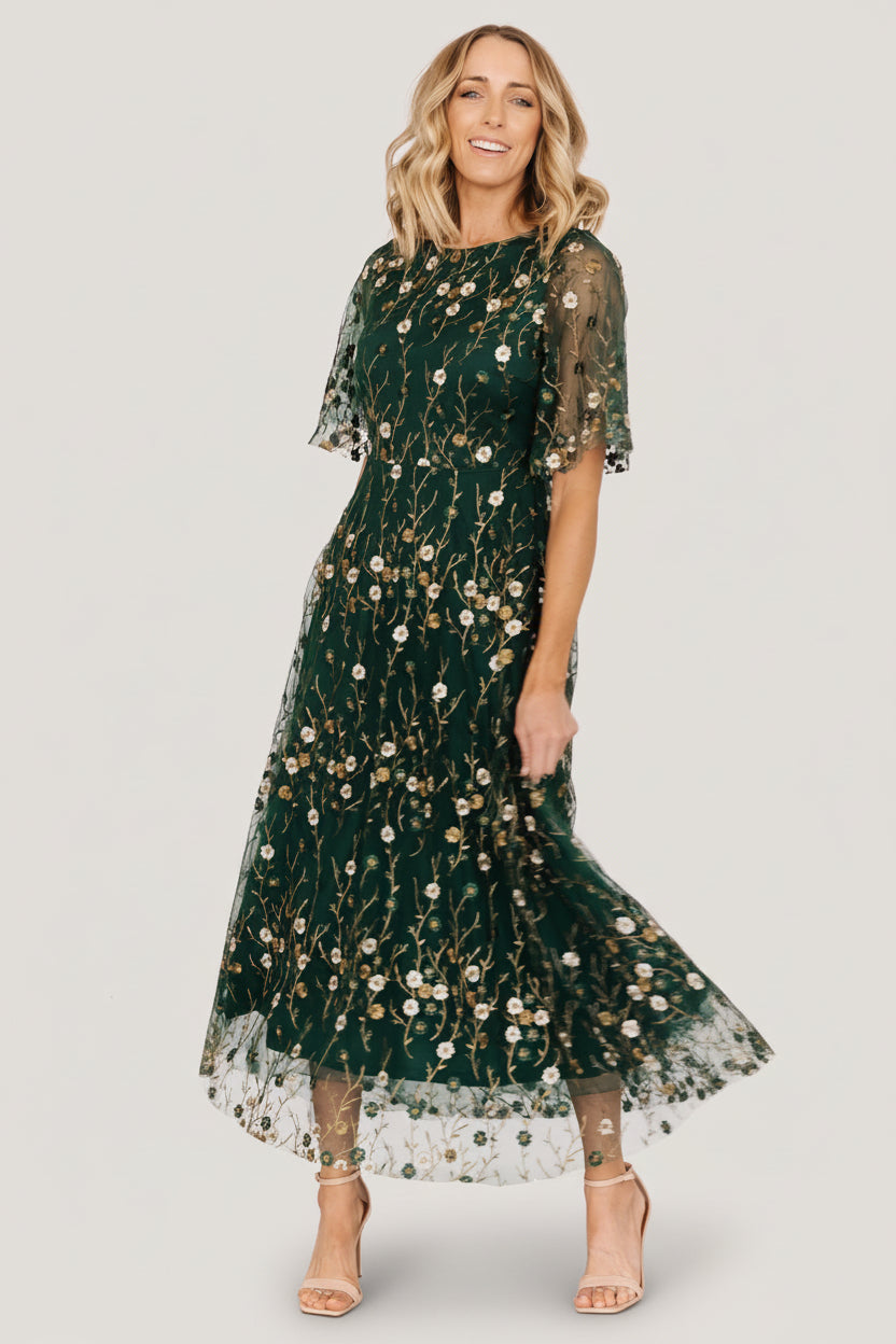 Side view of Arabella embroidered tulle maxi emphasizing layered skirt, gentle drape, and feminine silhouette.