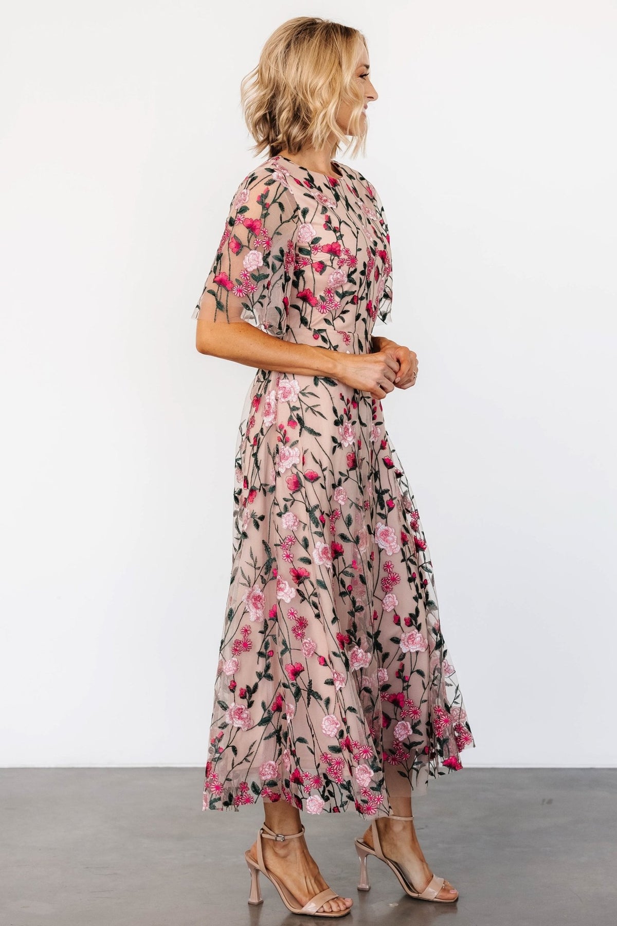 Full-length view of the maxi skirt highlighting layered tulle, extra volume and the dress's soft drape in muted blush tones.
