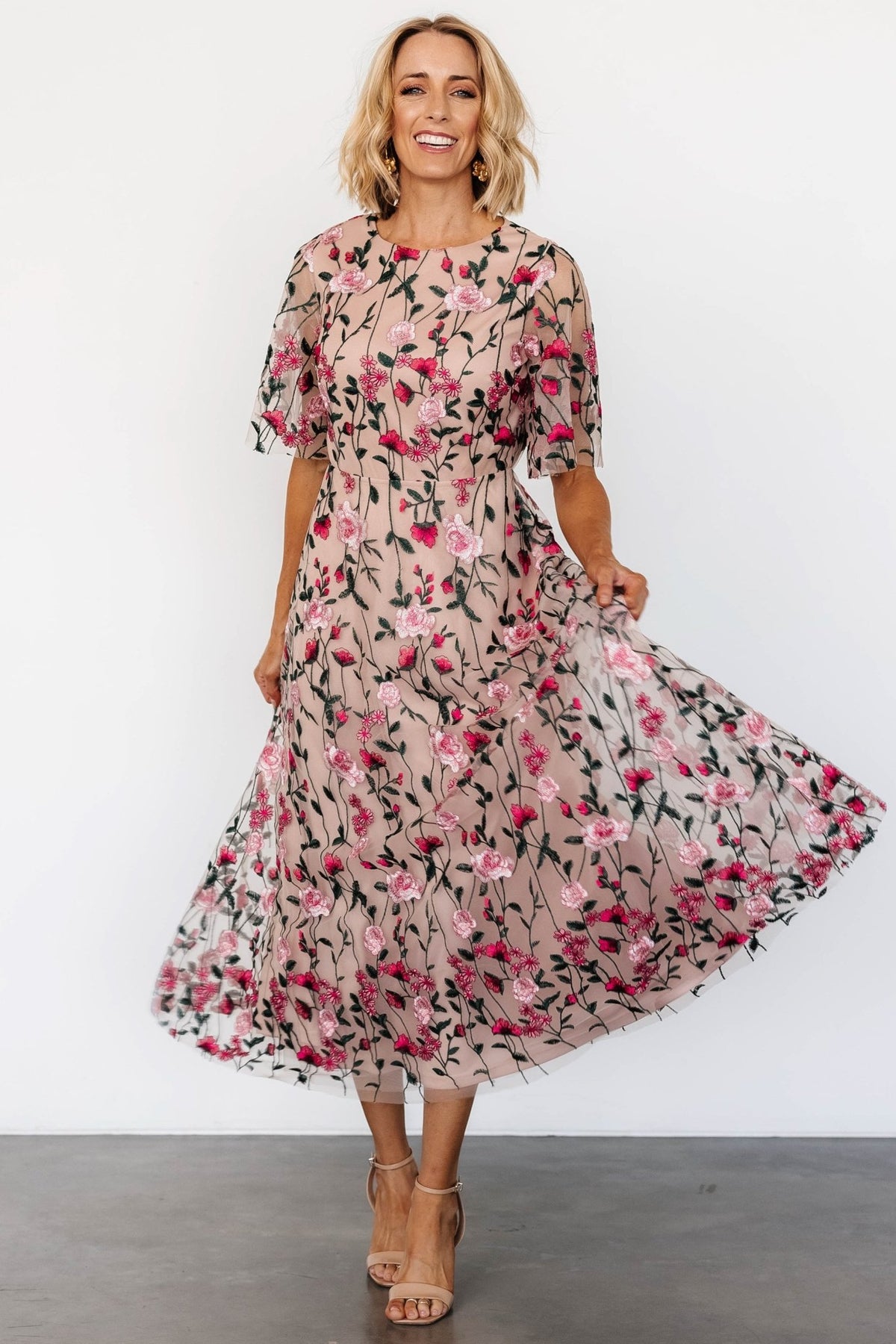 Back view showing keyhole and single-button closure above an elastic back waist for flexible fit and easy dressing.