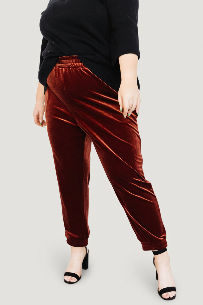 Side view close-up of Archie velvet joggers in cinnamon, showing hidden side pocket and the smooth velvet texture.