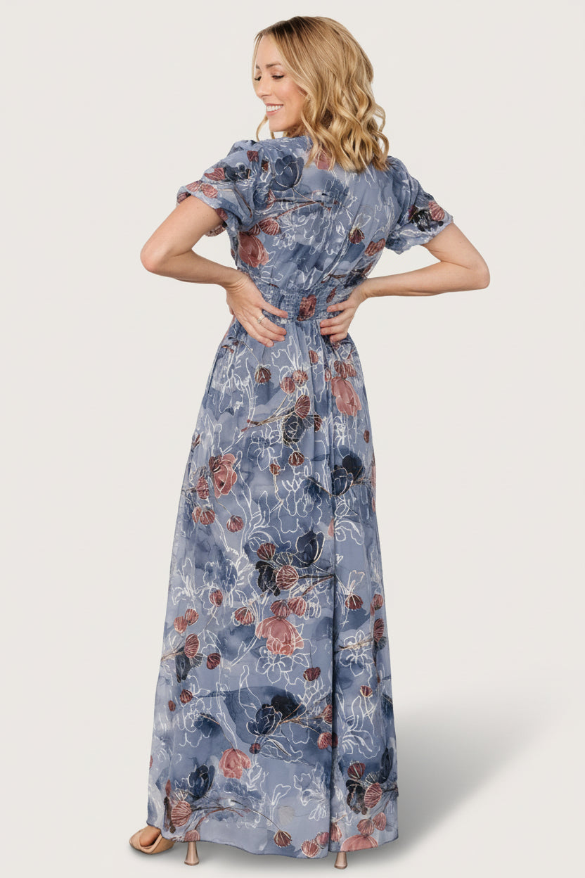 Detail shot of skirt movement and embroidered floral pattern on the Ardley Maxi Dress in Slate Print, emphasizing flow and event-ready polish.