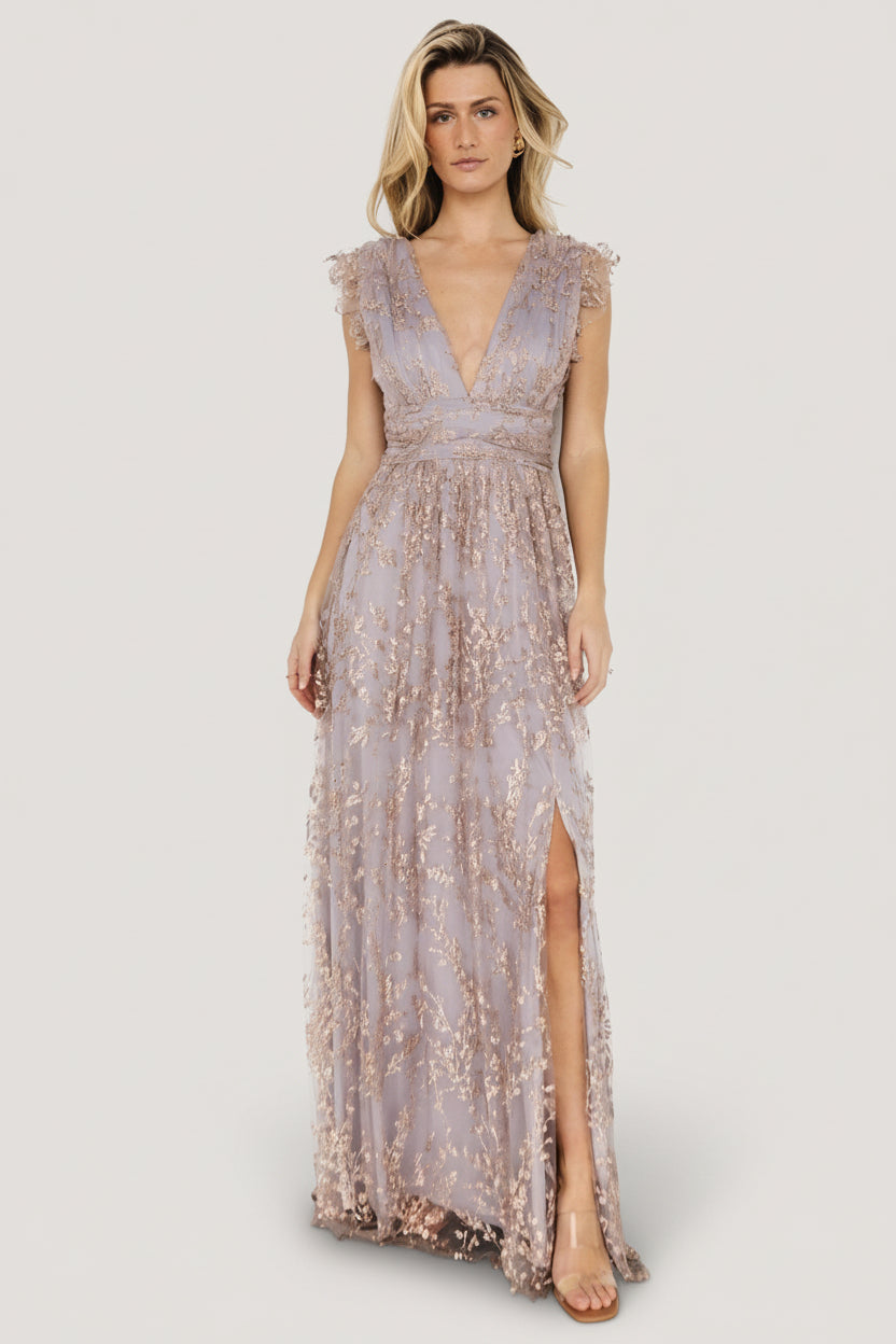 Three-quarter angle showing shimmer tulle overlay and rose-gold floral pattern with banded waist and flowing maxi skirt.