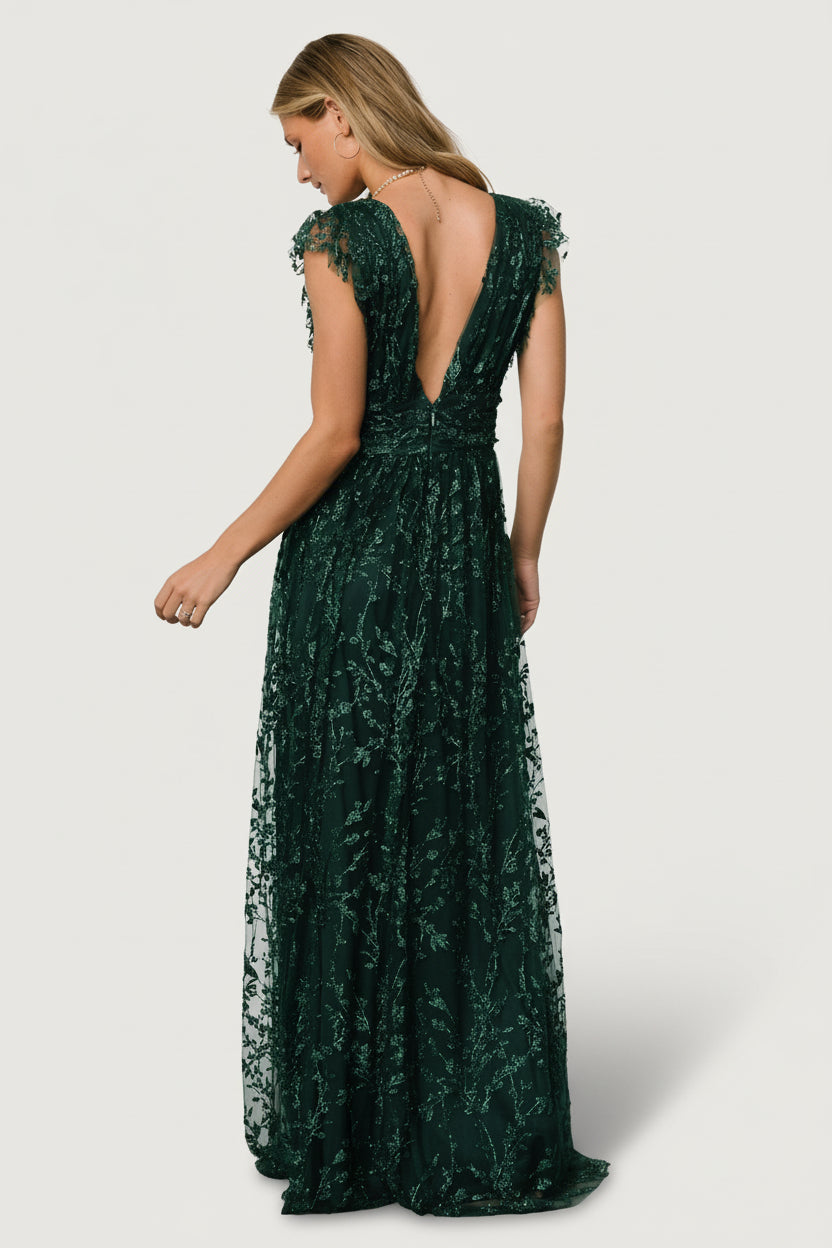 Detail image of shimmer tulle and sequin floral pattern on the Arlene Shimmer Gown, showing texture and reflective sparkle against emerald lining.