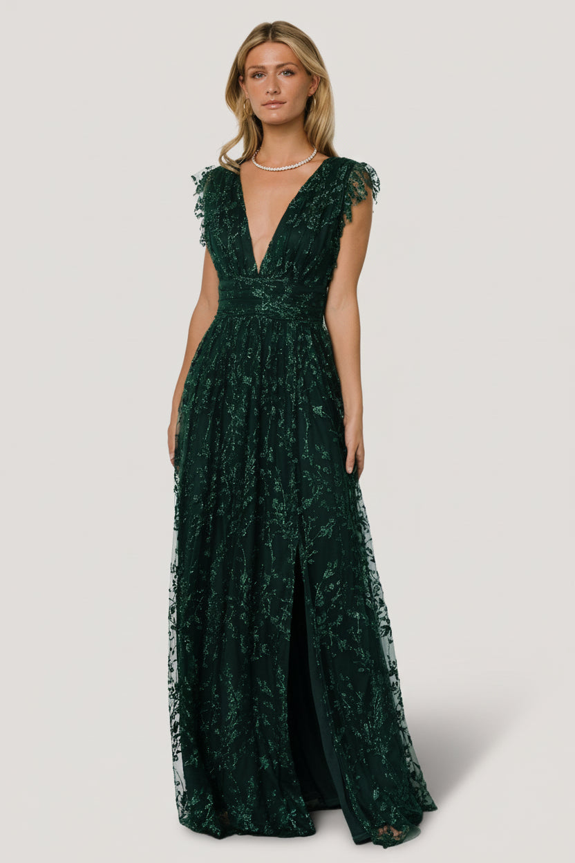 Front view of Arlene Shimmer Gown in emerald showing deep V-neck, shimmer tulle overlay, glittered floral sequin pattern, and high-waisted silhouette.