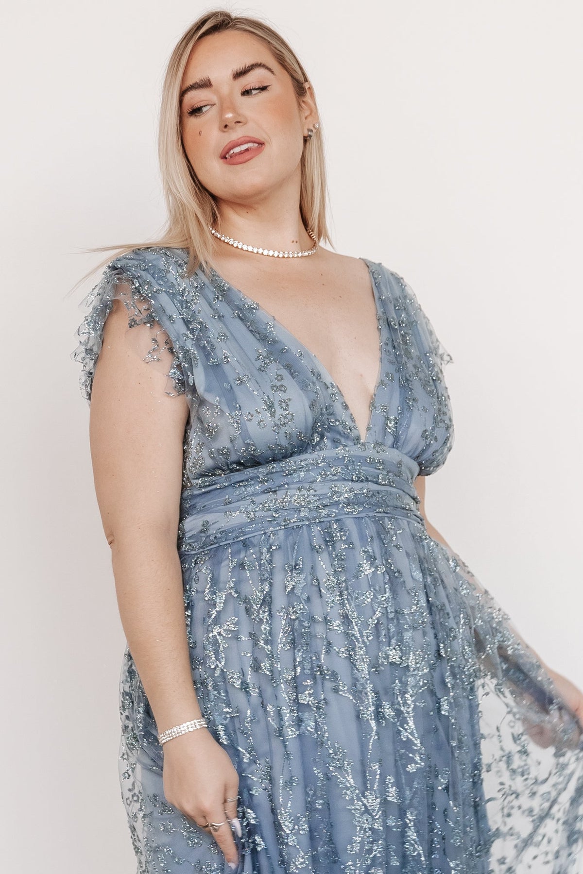 Fabric and texture detail of the Winter Blue gown: shimmer tulle overlay over blue lining with scattered floral sparkle across the skirt.