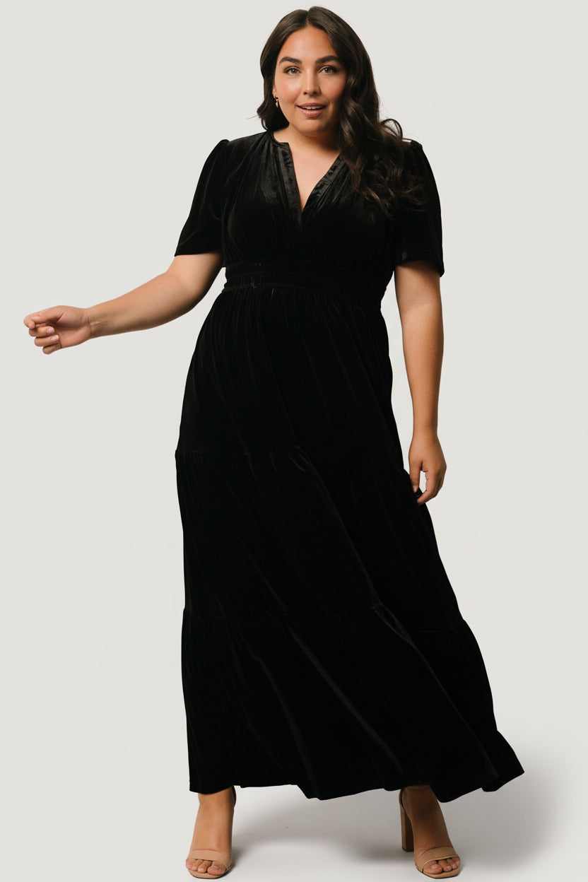 Close-up of black velvet fabric texture and subtle sheen on the Artemis tiered maxi dress, highlighting soft hand and pile.