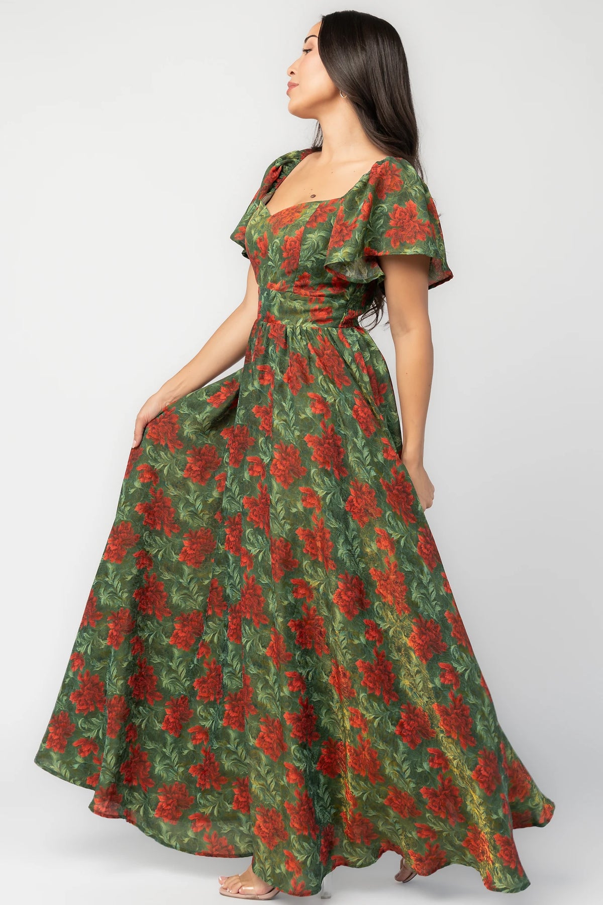 Astor Maxi Dress in Green + Red with floral print, sweetheart neckline, flutter sleeves, smocked back, and flowing skirt.