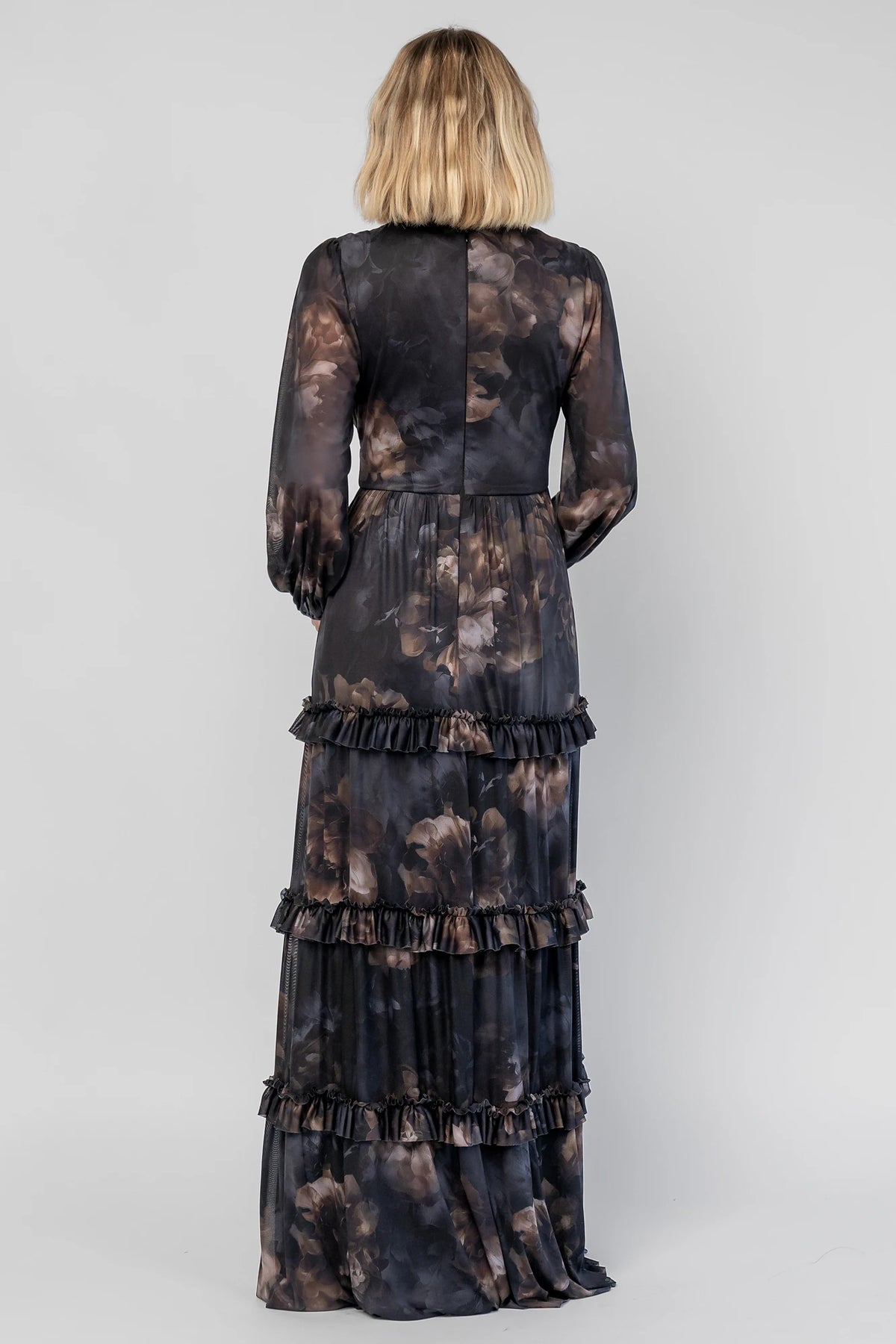 Astraea Maxi Dress in Midnight Floral with a deep V-neckline, sheer sleeves, and a tiered maxi skirt with leg slit.