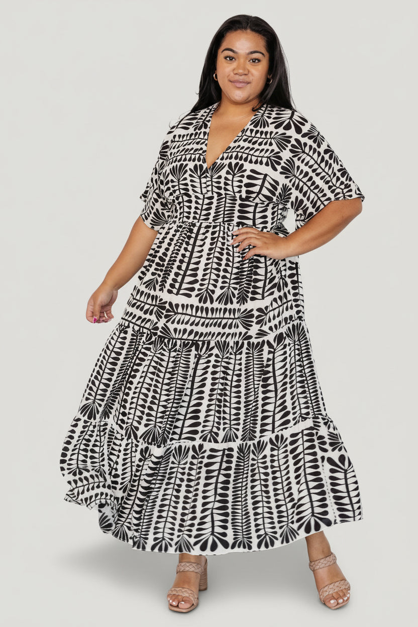 Back detail of Austin Kimono Dress highlighting the smocked elastic waistband and gentle gathers at the waist in black print fabric.
