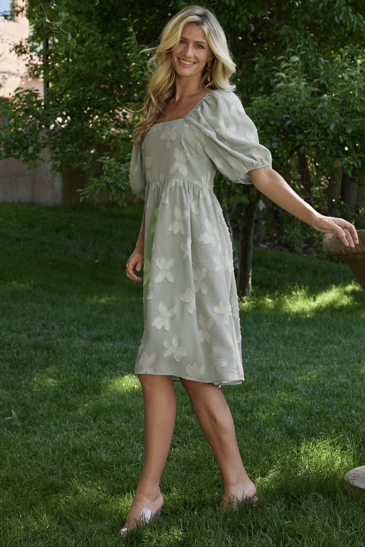 Close-up showing functional side pocket and smooth lined bodice and skirt fabric on the sage short dress.