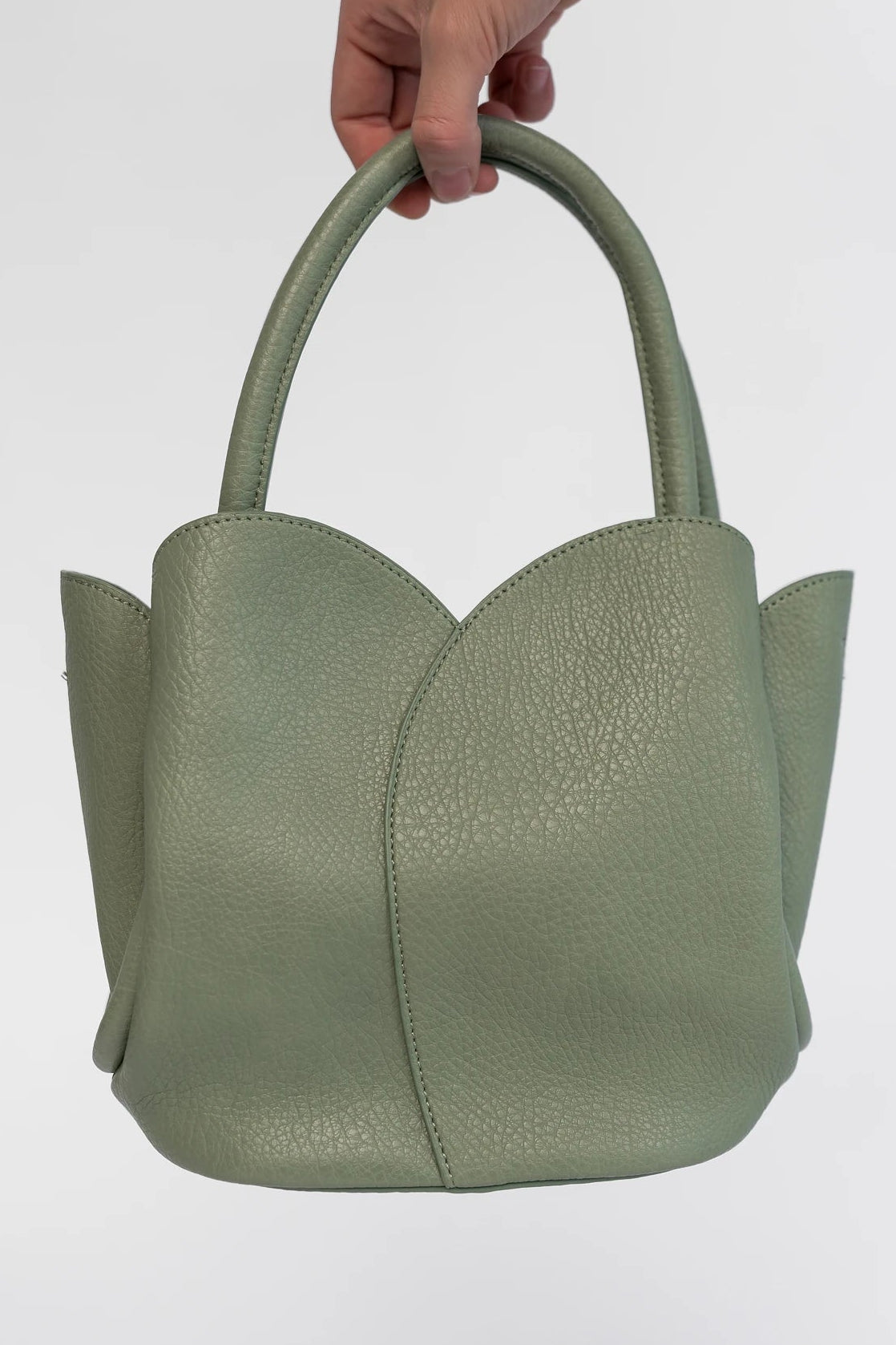 Beloved Tulip Tote Bag in Moss with a soft pebbled texture, tulip-inspired panel detailing, and rounded top handles.