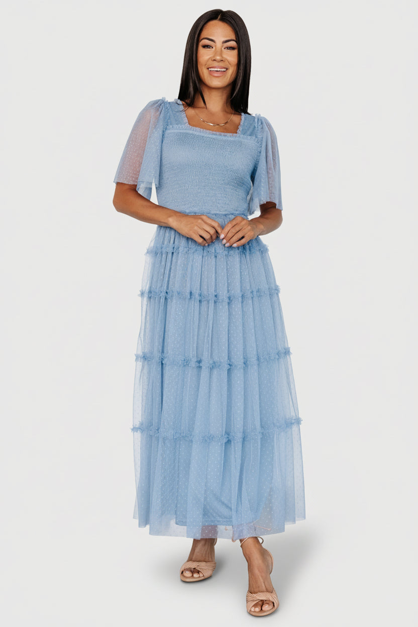 Front view of dusty blue dotted tulle midi dress showing elastic square neckline, smocked bodice and tiered ruffle skirt.