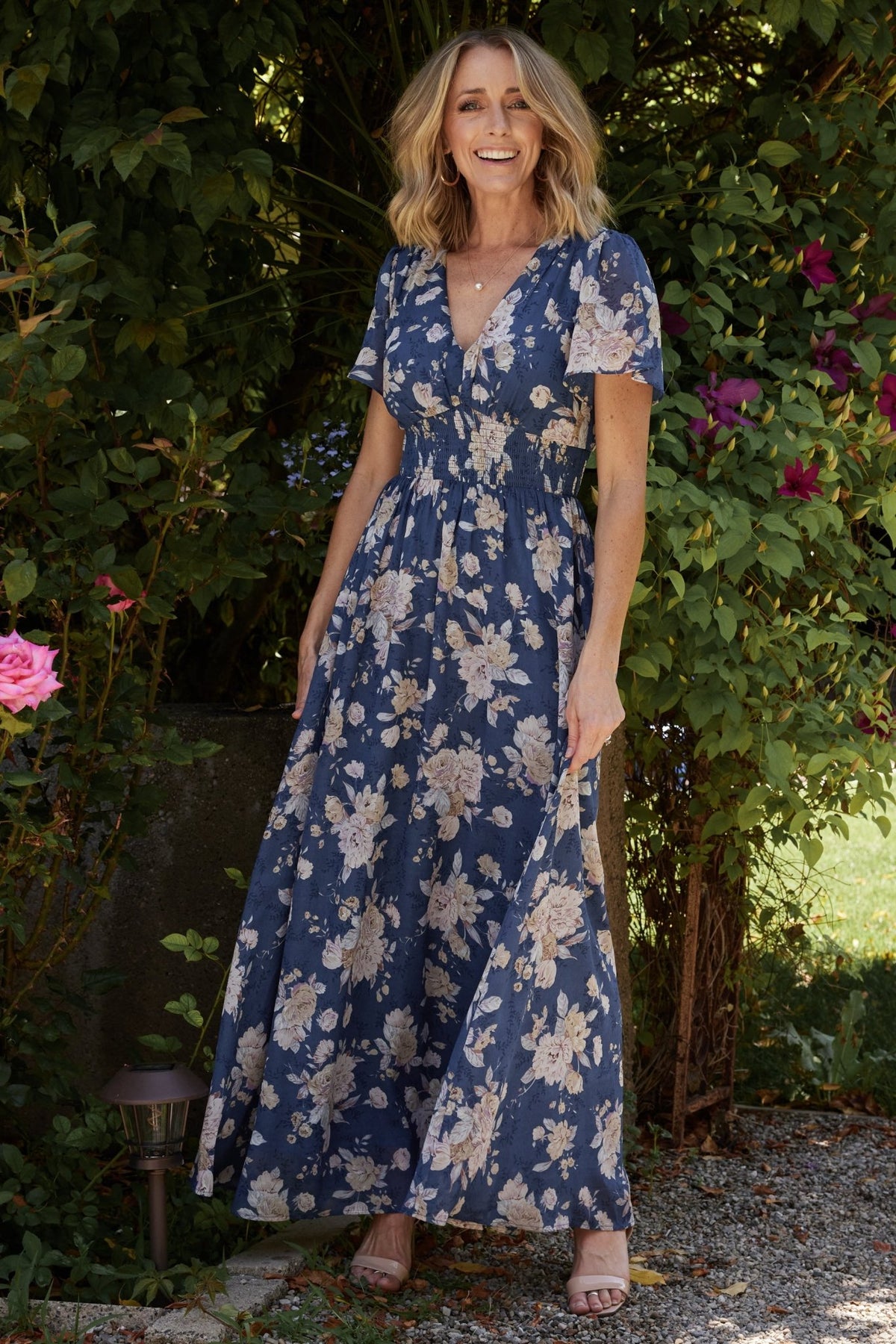 Full-length shot of Birdie maxi dress in blue and blush floral; flowing skirt movement, soft drape, and comfortablelined silhouette.