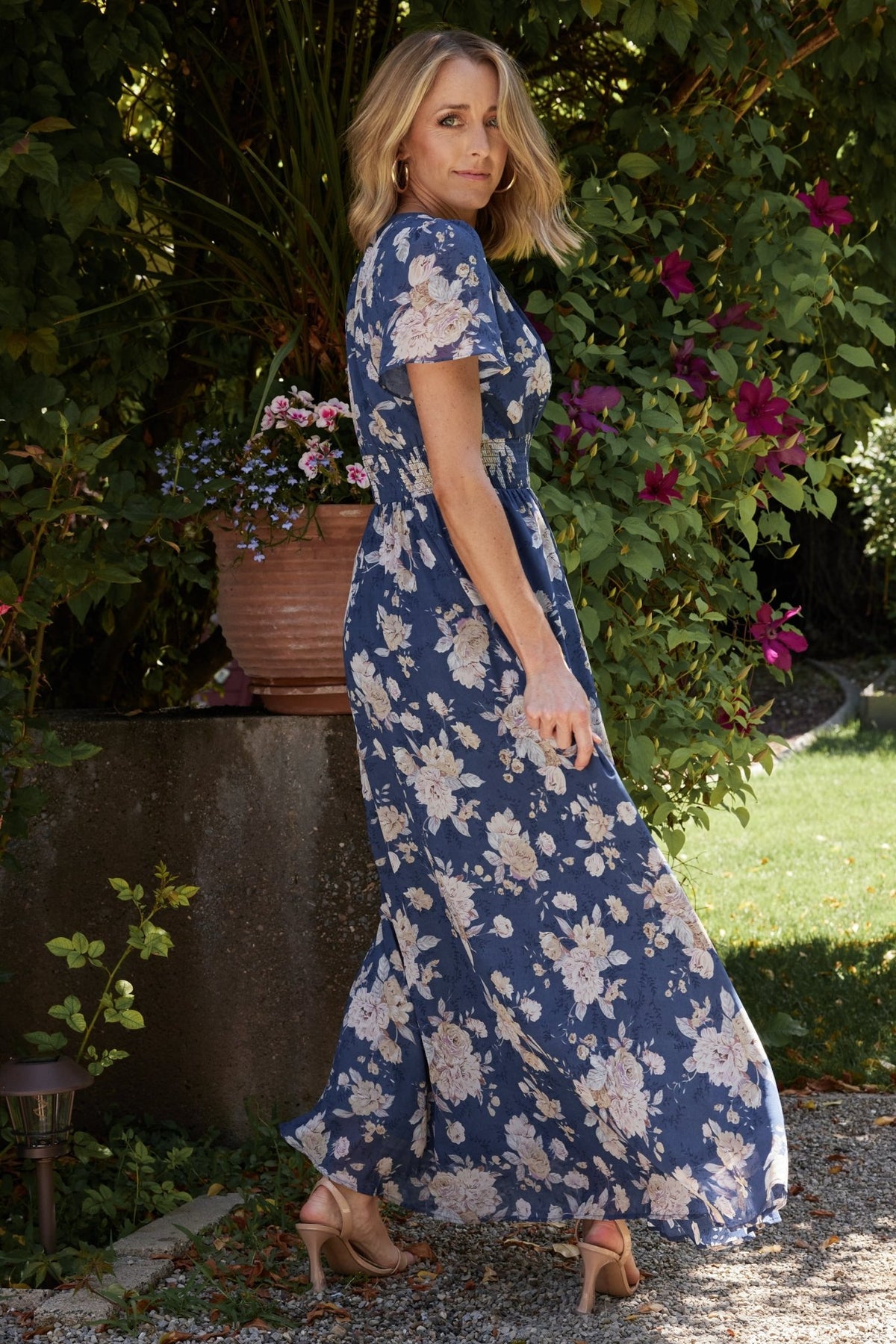 Back view of Birdie maxi dress highlighting smocked waist, gentle skirt fullness, and lined skirt with unlined flutter sleeves.