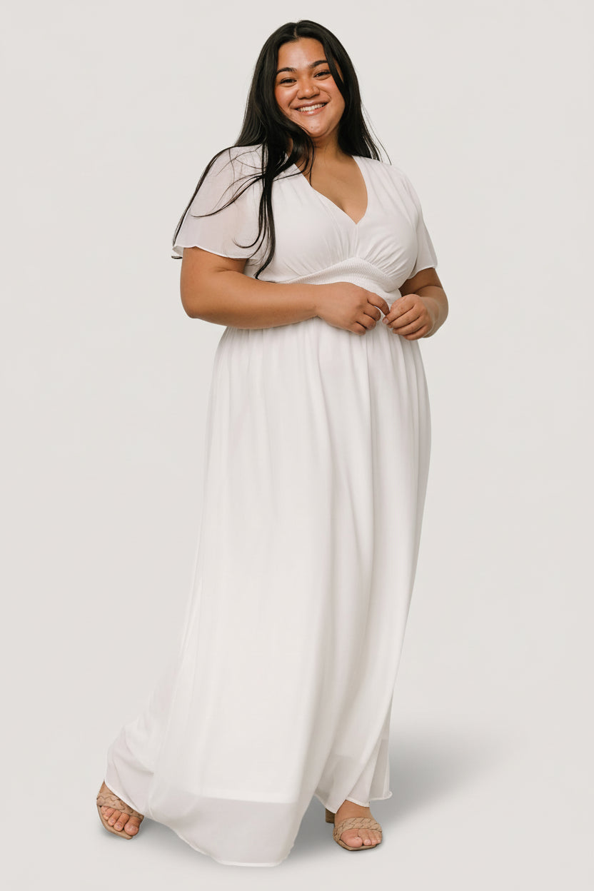 Three-quarter view of the Birdie white chiffon maxi dress highlighting smocked waist, soft pleating and flowing chiffon skirt movement.