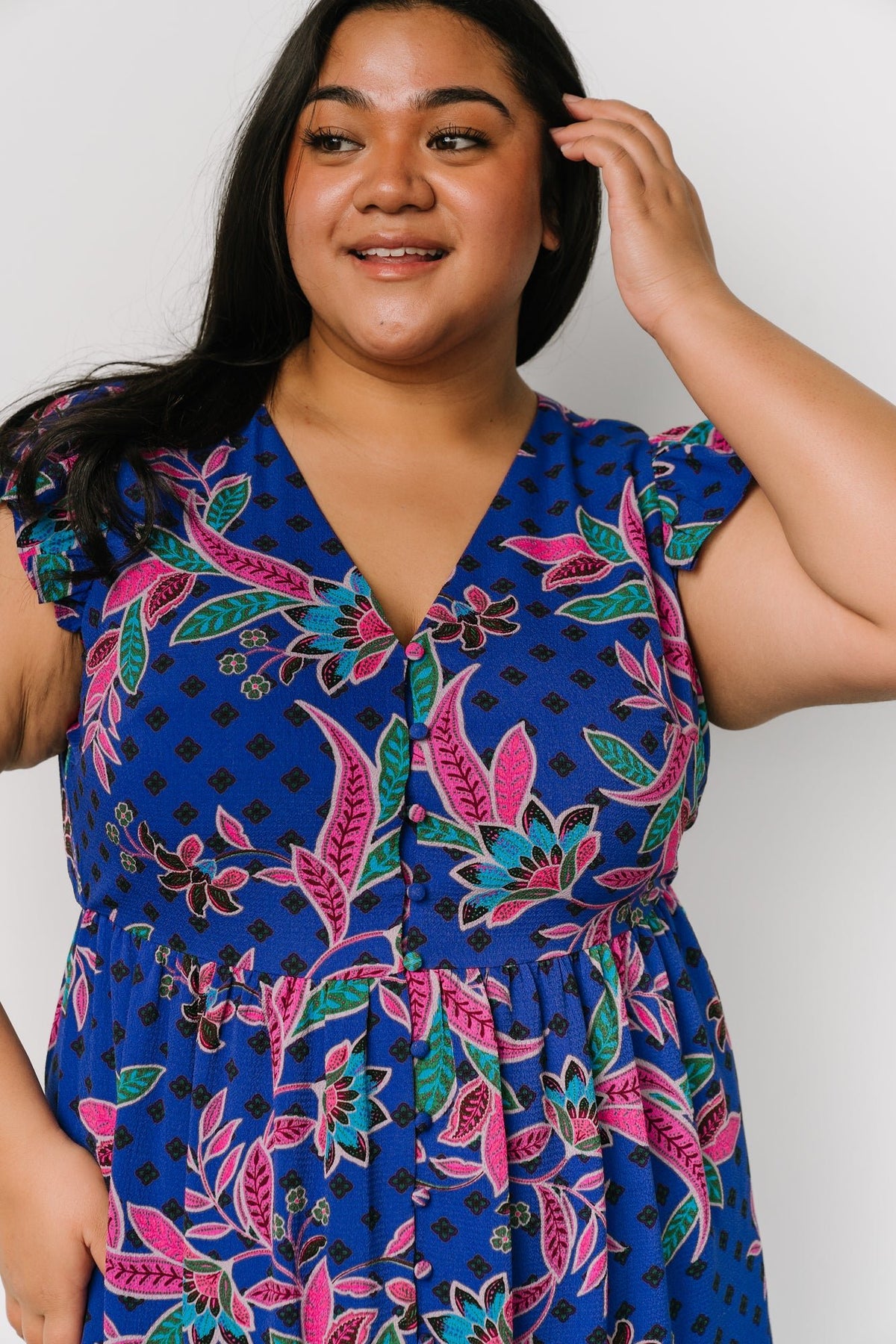Model wearing the indigo dress styled with sandals; image shows functional side pocket access and natural fabric drape.
