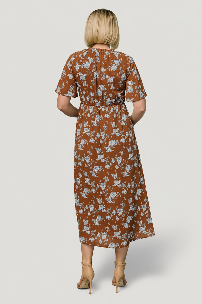 Side profile of the midi dress highlighting the elasticized waist, side pocket opening, and the flow of the attached lined skirt in floral print.