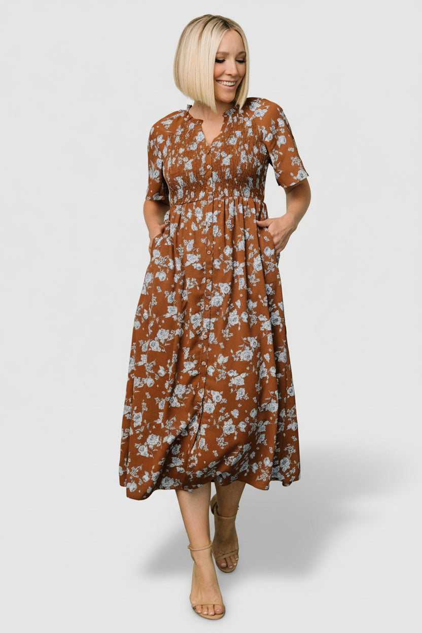 Detail image showing fabric texture and print close-up of brown ground with delicate blue floral motifs and smooth attached lining.