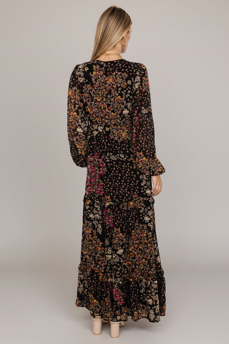 Bowman Deep V Tiered Maxi Dress in Black Multi with deep V-neck, long sleeves, ruffle-tiered skirt, and leg slit.