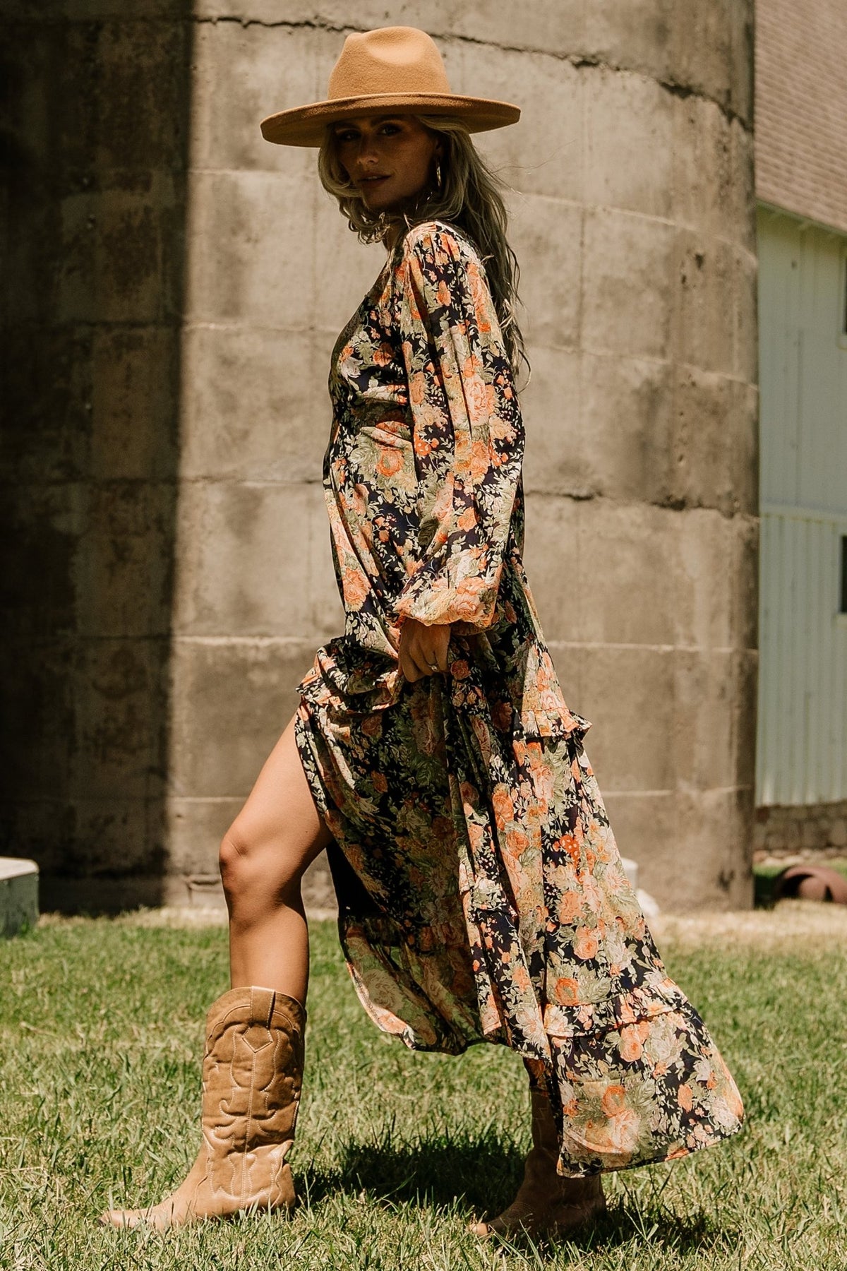 Side profile of navy floral maxi dress highlighting the cute leg slit, elastic back waist and flowing chiffon silhouette.