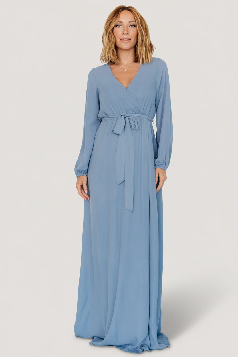 Detail image of long sleeve with elastic cuff on Breanne Faux Wrap Maxi Dress in slate blue showing fabric texture and cuff finish.